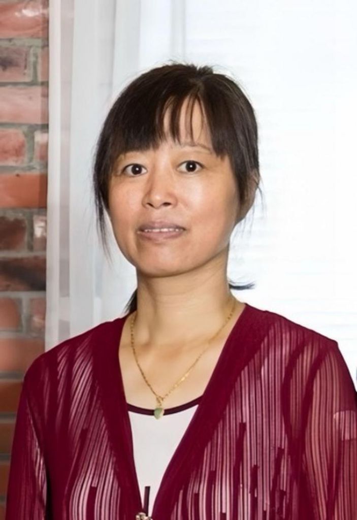 Example tribute photo — gentle candlelight (placeholder) for YanQin “Lilly” Lin